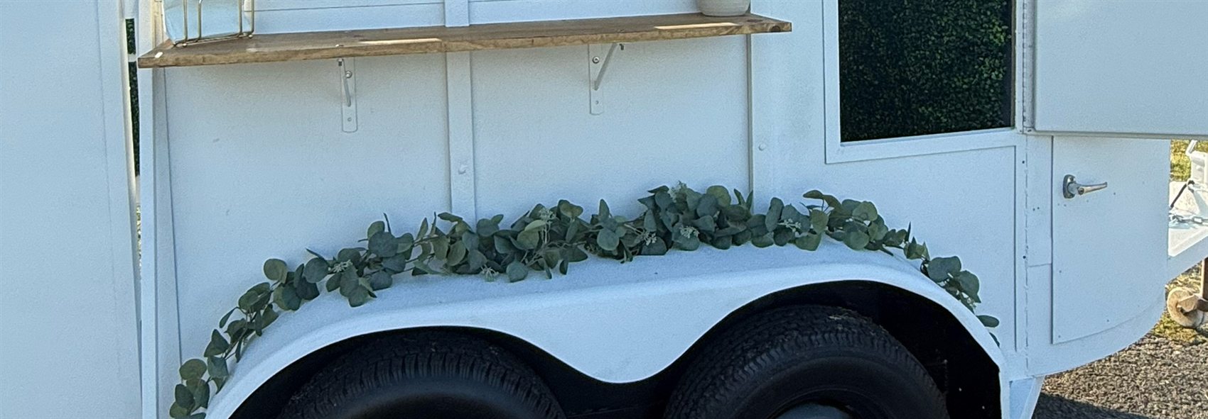 The Boujee Buggy trailer with eucalyptus garland along the fender